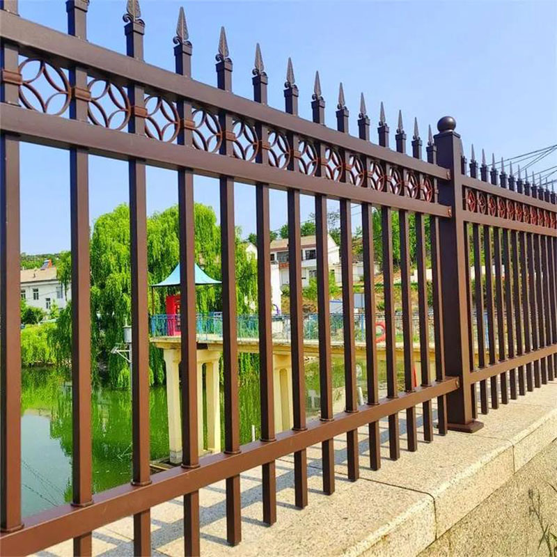 Brown steel fence being assembled